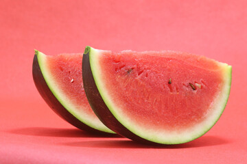 slice of fresh watermelon isolated on red background