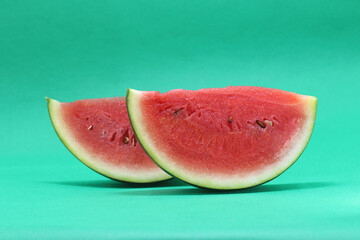 Fototapeta na wymiar slice of fresh watermelon isolated on green background