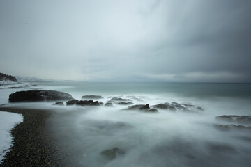 LONG EXPOSURE ON THE BEACH IN A BLACK SEA WAVY AND COLD WINTER DAY