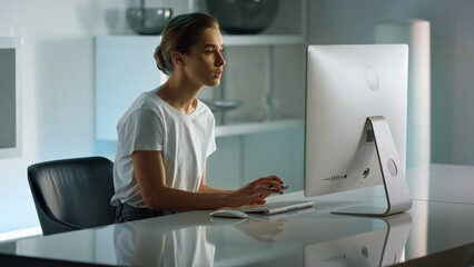 Happy freelancer communicating online at home office. Joyful girl finishing call