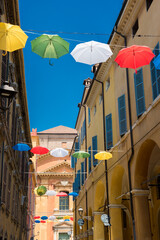 Fototapeta na wymiar Umbrellas installation on the streets of Modena, Italy.