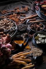 Various Thai and Chinese herbs in ceramic bowl on a dark background. Herbal and Spices Oriental marketplace.