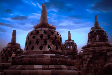 Huge stone Buddhist stupas at night in the Borobudur Temple.  Java island. Indonesia. Famous historical place. Outside. Religion concept.