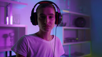 Focused esport player looking camera closeup. Professional streamer in neon room © stockbusters