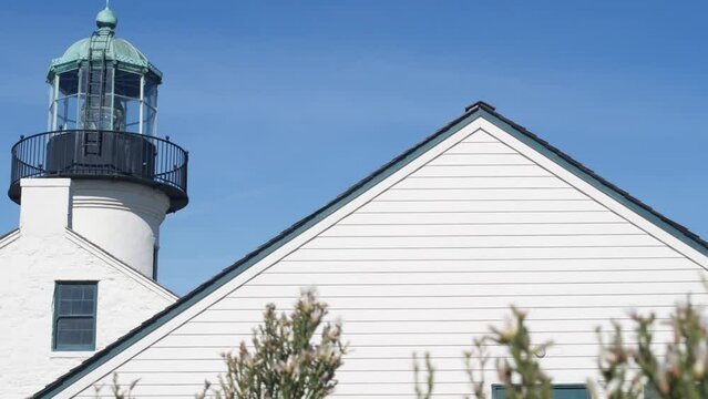 Vintage lighthouse tower, retro light house, old fashioned historic classic white beacon with fresnel lens. Nautical navigational coastal building 1855. Point Loma, Cabrillo, San Diego, California USA