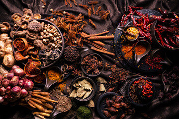 Top view of various herbs and spices for cooking in bowls. Selective focus