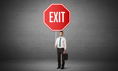 Young business person holding road sign