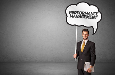 business person in casual holding road sign