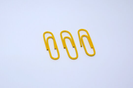 Closeup Of Yellow Paper Clips Isolated On A White Background