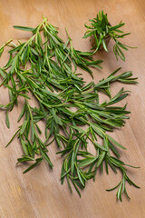 Sprigs of green rosemary on brown background