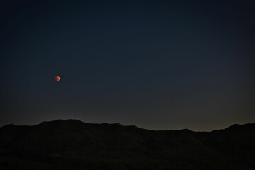 Mysterious view of a night sky with red moon in Los Angeles, California, USA