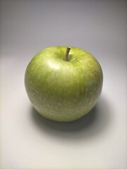closeup of sour apple green color with gray background
