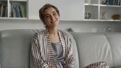 Attractive lady resting living room closeup. Relaxed girl posing in pajamas