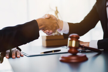 Businessman shaking hands to seal a deal with his partner lawyers or attorneys discussing a contract agreement.