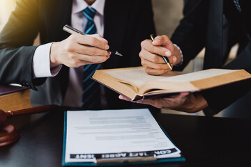 male lawyer discuss to a legal document explaining the terms of a consultation with a businessman....