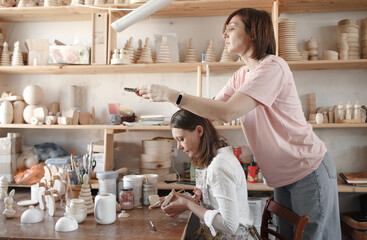 a girl master in the production of wooden toys shoots a video blog in her own workshop.