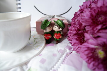 A bright smile with a sweet scent of love side by side is decorated with pink flowers and served with coffee.