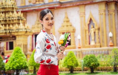 Beautiful Asian girl at big Buddhist temple dressed in traditional costume