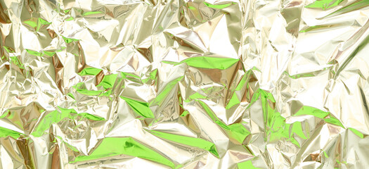 Abstract silver aluminum wrinkled foil multicolored background texture reflecting green light....