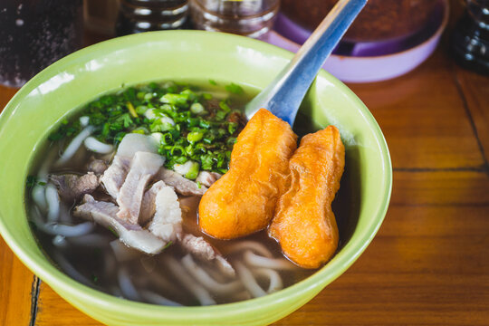 Lao pork noodle soup or "Khao Piak Sen" with Deep-fried dough stick Pa-tong-ko at morning market in Luang Prabang, Laos.