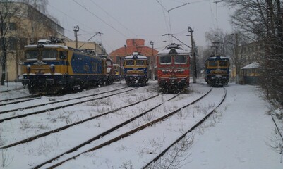 View of locomotives driving on snowy railroads in winter