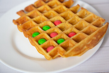 Front view on homemade waffles with chocolate buttons inside. Celective focus