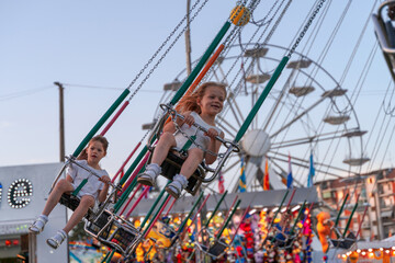 two happy sisters little girls having fun at the amusement park