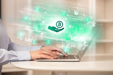 Young man watching stock market on laptop