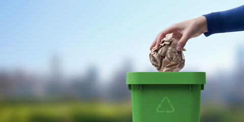 Woman putting paper in the trash bin