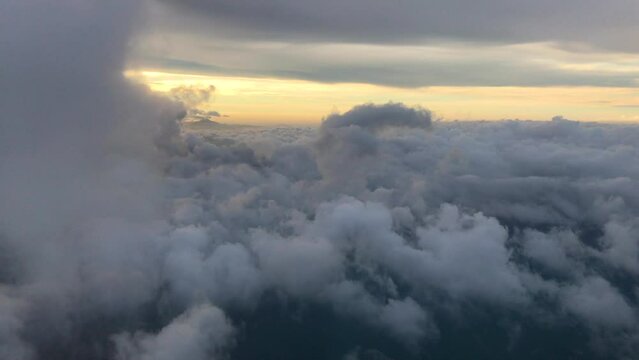 Flight over the cloud Incredibly beautiful landscape, mist ann foggy in the rays of the setting sun.