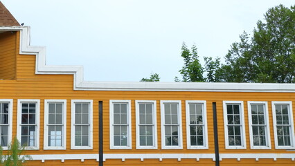 yellow building with white windows on white background - Powered by Adobe