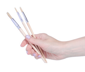 Paint brushes in hand on white background isolation