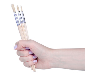 Paint brushes in hand on white background isolation