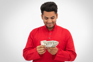 Man counting Indian currency happily