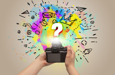 Close-up of a hand holding digital camera with abstract drawing concept