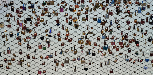 The fence of the bridge hung with many colored locks, Salzburg, Austria, background, texture