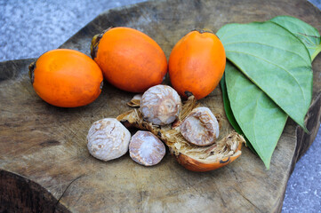Betel nut with betel leaf isolated on wooden background. Copy space