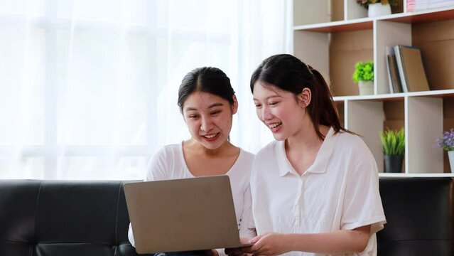 Two Asian women are on a video call with a friend. homosexual relationship, gay couple, advocating sexual independence and pride in LGBTQ. Lgbt and love relationship. Supporters of the LGBT community.