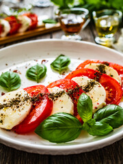 Caprese salad on wooden board
