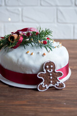 A branch of a green Christmas tree and a festive dean on a German traditional Christmas cake Stollen. Christmas present. Merry Christmas holiday.