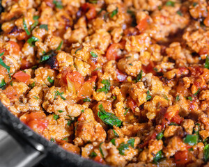 Preparation of bolognese sauce. Bolognese sauce in a frying pan, closeup