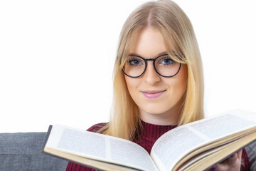 Portrait of young woman with glasses and an open book closeup. Isolated  on white background.