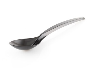 Plastic black disposable spoon isolated on a white background. Full depth of field. Close-up