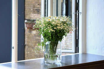 Bouquet of flowers at the open window