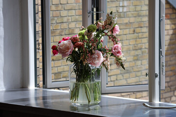 Bouquet of flowers at the open window