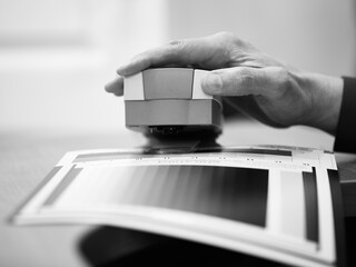 man calibrates photo paper before printing