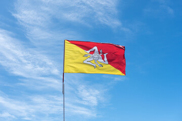 
Sicilian flag waving in the wind with the blue sky in the background