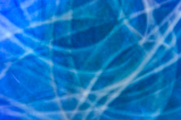 Fototapeta na wymiar Abstraction in blue tones with large wave lines and abrasions
