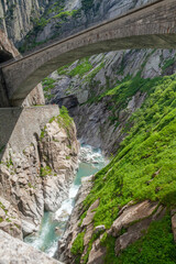 Fototapeta na wymiar Old stone bridge in Switzerland mountains