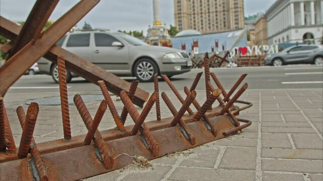 anti-tank hedgehogs and prickly spikes that can pierce the wheels of a car on the central square of the city of Kyiv. protective military constructions. Slow Motion 100fps 2.8k